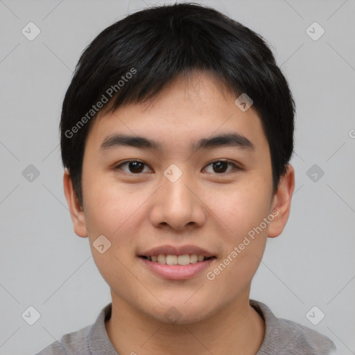 Joyful asian young-adult male with short  black hair and brown eyes