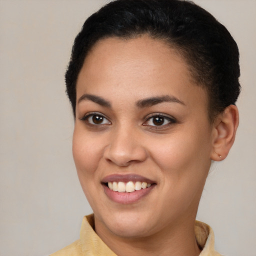 Joyful latino young-adult female with short  brown hair and brown eyes
