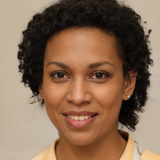 Joyful black young-adult female with short  brown hair and brown eyes