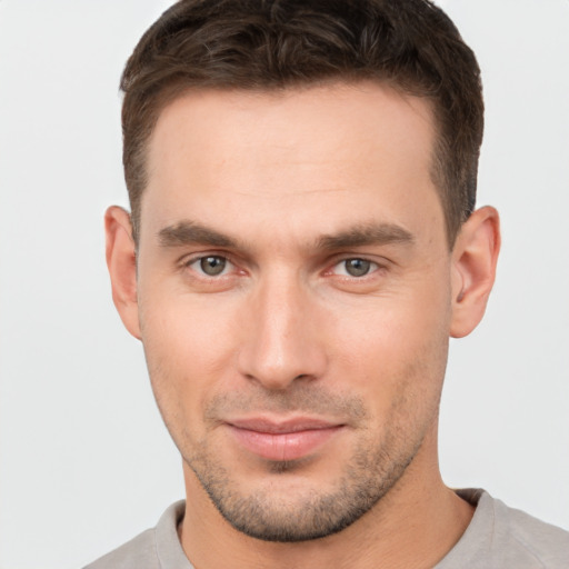 Joyful white young-adult male with short  brown hair and brown eyes