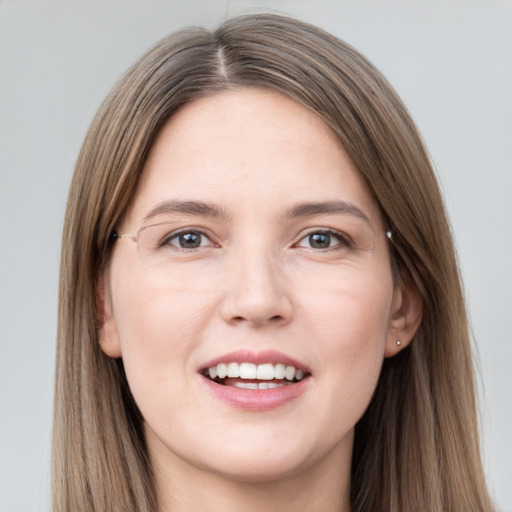 Joyful white young-adult female with long  brown hair and grey eyes