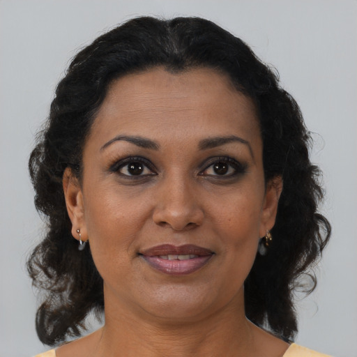 Joyful black adult female with medium  brown hair and brown eyes