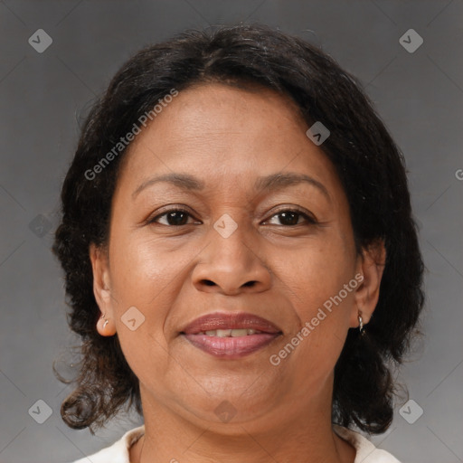 Joyful black adult female with medium  brown hair and brown eyes