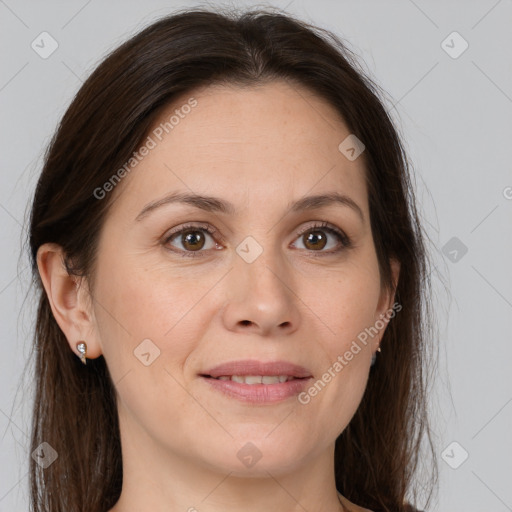 Joyful white adult female with long  brown hair and brown eyes