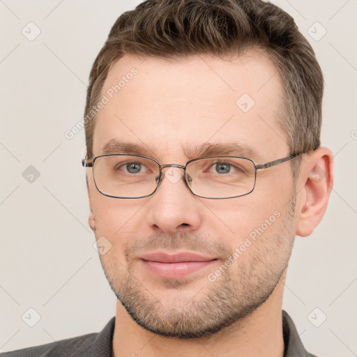 Joyful white adult male with short  brown hair and grey eyes