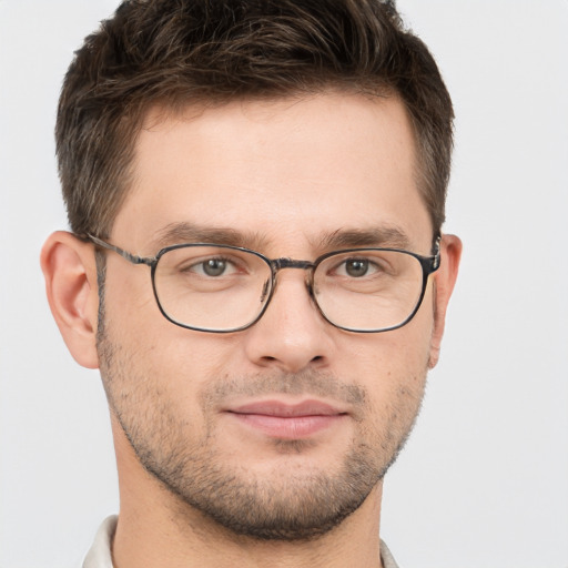 Joyful white young-adult male with short  brown hair and brown eyes