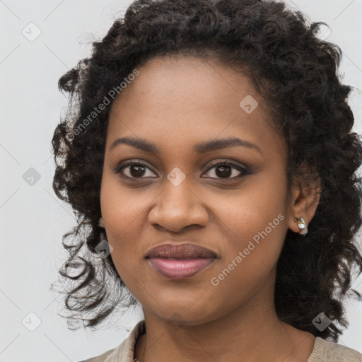 Joyful black young-adult female with long  black hair and brown eyes