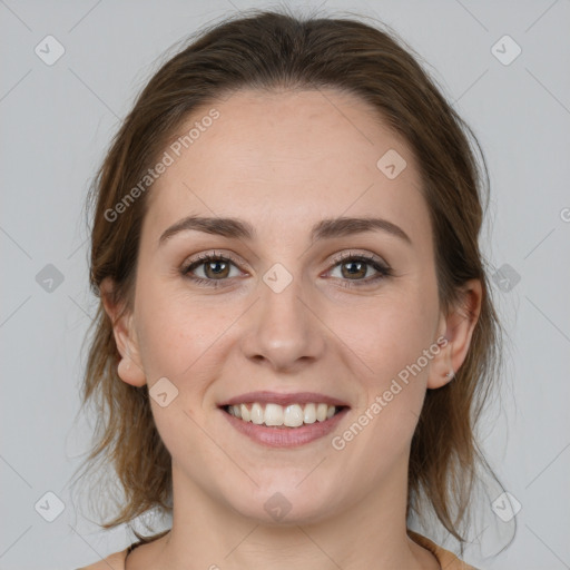 Joyful white young-adult female with medium  brown hair and grey eyes