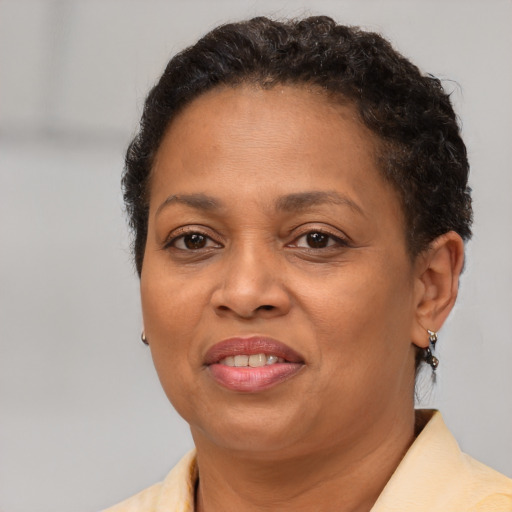 Joyful black adult female with short  brown hair and brown eyes