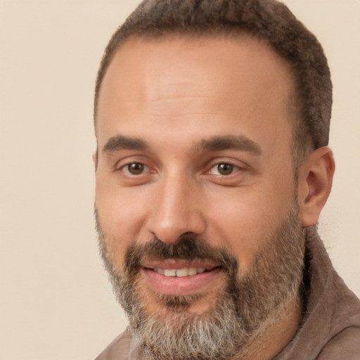 Joyful white adult male with short  brown hair and brown eyes