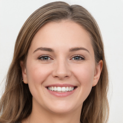 Joyful white young-adult female with long  brown hair and grey eyes