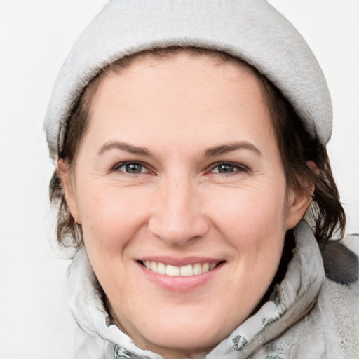 Joyful white adult female with medium  brown hair and grey eyes