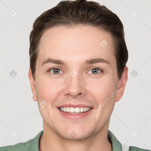 Joyful white young-adult male with short  brown hair and grey eyes