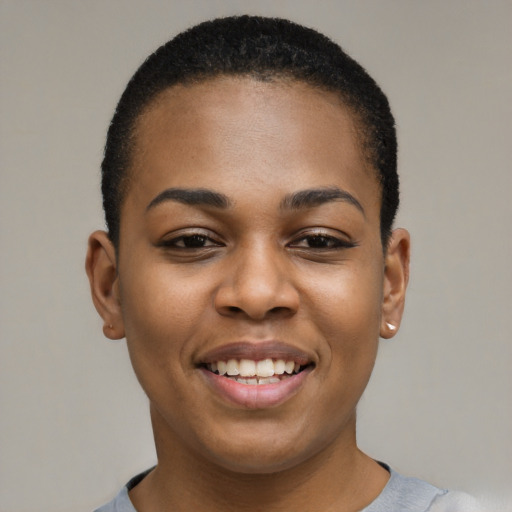 Joyful black young-adult female with short  black hair and brown eyes