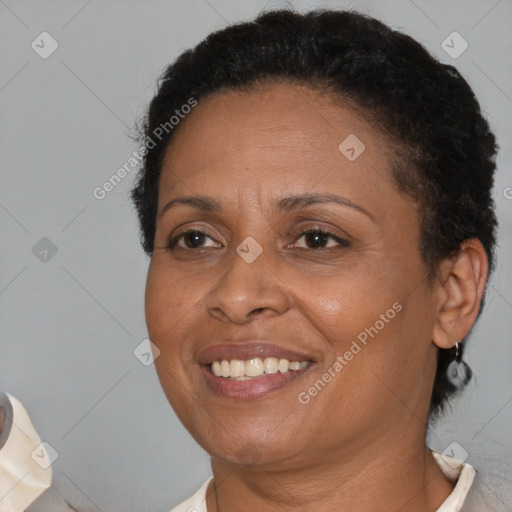 Joyful black adult female with short  brown hair and brown eyes