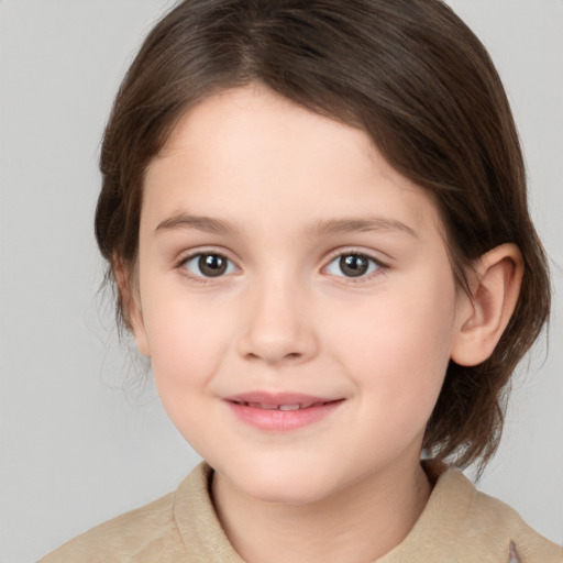 Joyful white child female with medium  brown hair and brown eyes