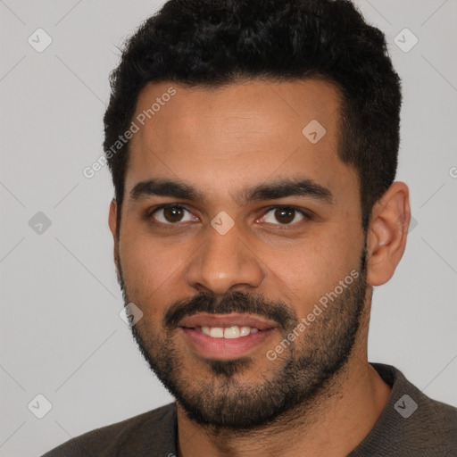 Joyful latino young-adult male with short  black hair and brown eyes