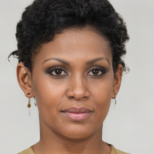 Joyful black young-adult female with short  brown hair and brown eyes