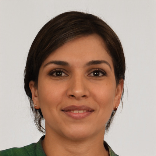 Joyful latino young-adult female with medium  brown hair and brown eyes