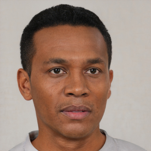 Neutral black adult male with short  black hair and brown eyes