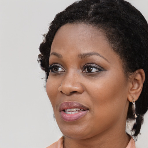 Joyful black young-adult female with medium  brown hair and brown eyes
