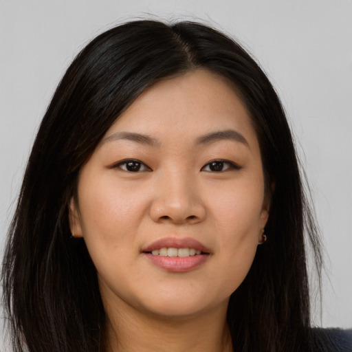 Joyful asian young-adult female with long  brown hair and brown eyes