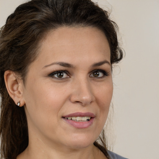 Joyful white adult female with long  brown hair and brown eyes