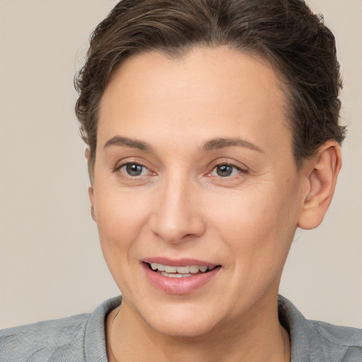 Joyful white adult female with short  brown hair and brown eyes