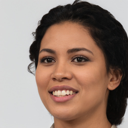 Joyful latino young-adult female with long  black hair and brown eyes