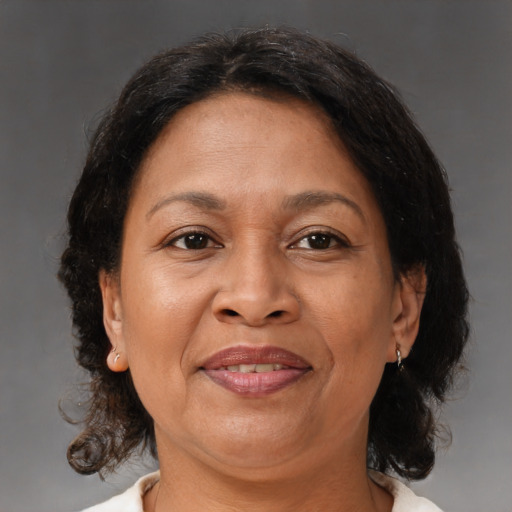 Joyful black adult female with medium  brown hair and brown eyes