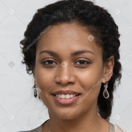 Joyful black young-adult female with long  brown hair and brown eyes