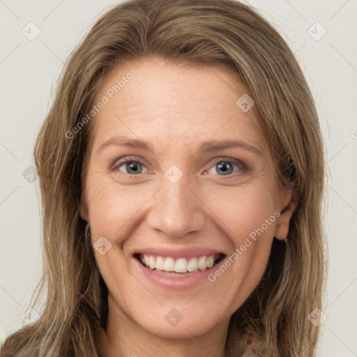 Joyful white young-adult female with long  brown hair and green eyes