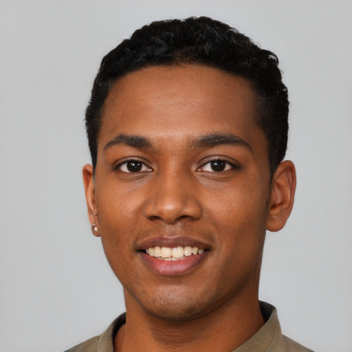 Joyful black young-adult male with short  black hair and brown eyes