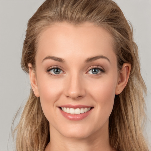 Joyful white young-adult female with long  brown hair and grey eyes