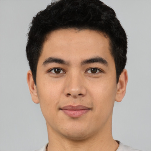 Joyful asian young-adult male with short  black hair and brown eyes