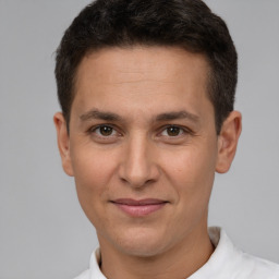 Joyful white adult male with short  brown hair and brown eyes