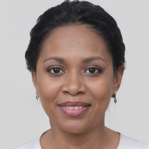 Joyful latino young-adult female with short  brown hair and brown eyes