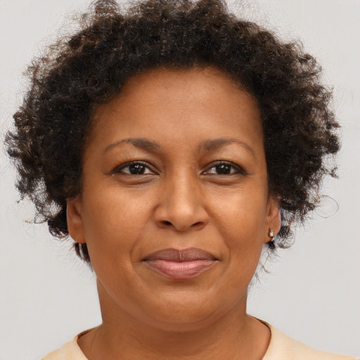 Joyful black adult female with short  brown hair and brown eyes