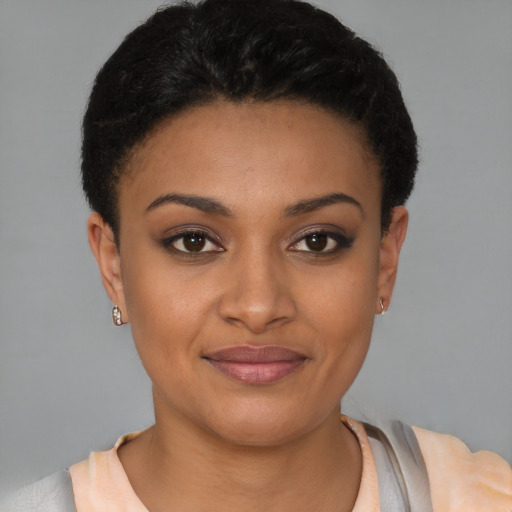 Joyful latino young-adult female with short  brown hair and brown eyes