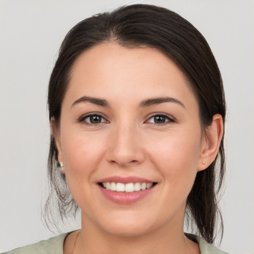 Joyful white young-adult female with medium  brown hair and brown eyes