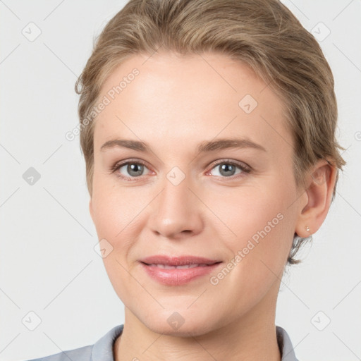 Joyful white young-adult female with short  brown hair and grey eyes