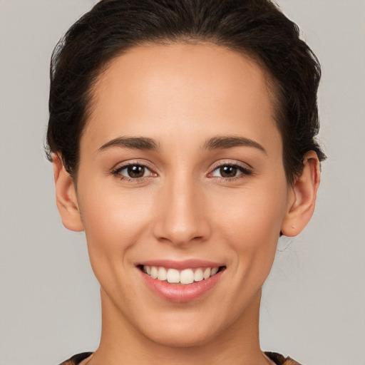 Joyful white young-adult female with medium  brown hair and brown eyes