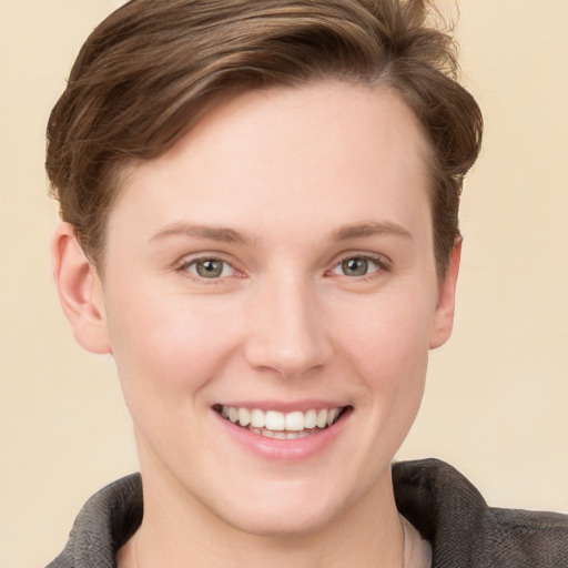 Joyful white young-adult female with short  brown hair and grey eyes