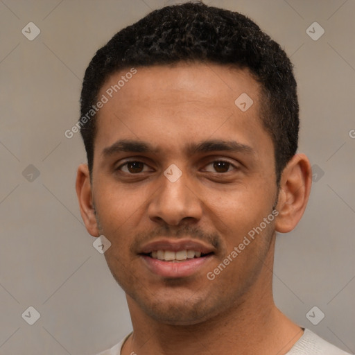 Joyful black young-adult male with short  black hair and brown eyes