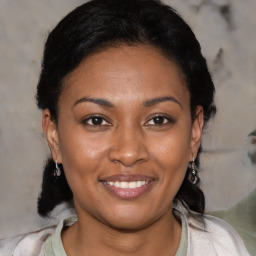 Joyful black young-adult female with medium  brown hair and brown eyes