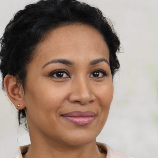 Joyful latino young-adult female with short  brown hair and brown eyes