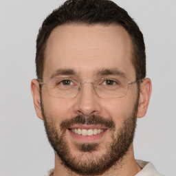 Joyful white adult male with short  brown hair and brown eyes