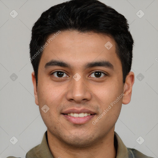 Joyful latino young-adult male with short  black hair and brown eyes