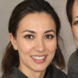 Joyful white young-adult female with medium  brown hair and brown eyes