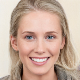 Joyful white young-adult female with long  brown hair and blue eyes